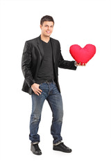 Canvas Print - Romantic young man holding a red heart