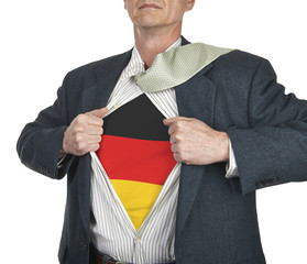 Businessman showing Germany flag superhero suit underneath his s