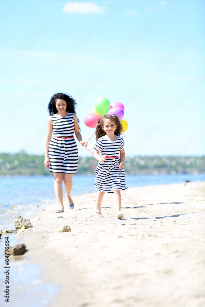 Happy mom and daughter on the beach