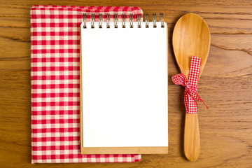 Canvas Print - Blank note book with wooden spoon on tabletop