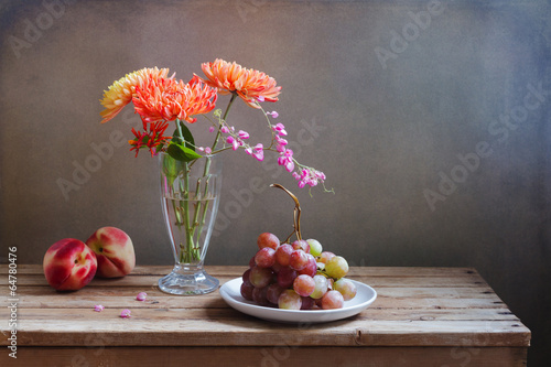 Fototapeta na wymiar Flowers and fruits on wooden vintage table