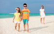 © TravelPhotoBloggers - Mother and kids on a tropical beach