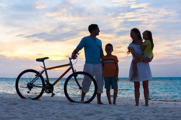 Wall Mural - family with a bike at tropical beach