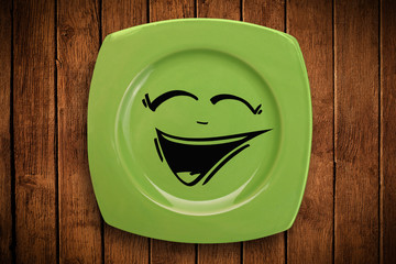 Happy smiley cartoon face on colorful dish plate