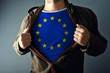 © Bits and Splits - Man stretching jacket to reveal shirt with European Union flag
