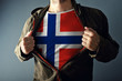 © Bits and Splits - Man stretching jacket to reveal shirt with Norway flag