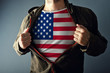 © Bits and Splits - Man stretching jacket to reveal shirt with USA flag