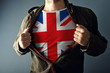 © Bits and Splits - Man stretching jacket to reveal shirt with great Britain flag