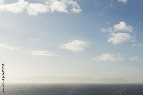Board z aluminiowym obramowaniem Chmury nad oceanem