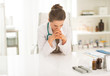 © Alliance - Concerned medical doctor woman sitting in office