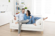 © jackfrog - cheerful couple relaxing in sofa at home