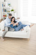 © jackfrog - cheerful couple using digital tablet in sofa at home