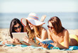 © Syda Productions - girls with tablet pc on the beach