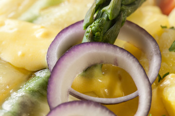 Asparagus baked with cheese served with buttered potatoes.