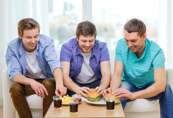 Poster - smiling friends with soda and hamburgers at home