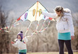 © Halfpoint - Pregnant mother and daughter with kite