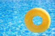 floating ring on blue water swimpool with waves reflecting