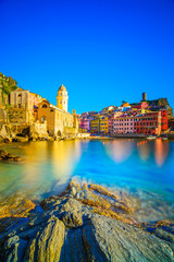 Wall Mural - Vernazza village, church, rocks and sea harbor on sunset. Cinque