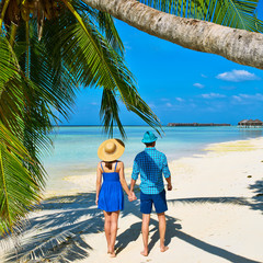 Couple in blue clothes on a beach at Maldives