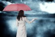 © WavebreakmediaMicro - Composite image of businesswoman holding umbrella