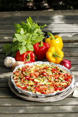 Canvas Print - Vegetable tart on rustic wooden table in the garden.