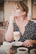 © polinaloves - Girl sitting in a cafe drinking coffee