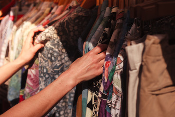 Woman browsing clothes at market