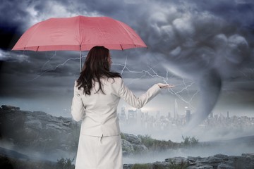 Wall Mural - Composite image of businesswoman holding umbrella