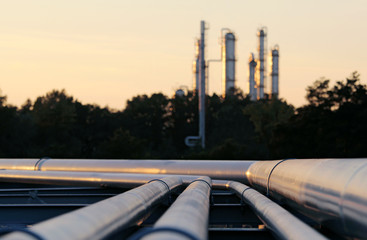 silhouette  of crude oil refinery station during sunset with lon