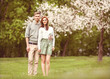 © Rock and Wasp - couple in love in blooming apple trees garden, smiling