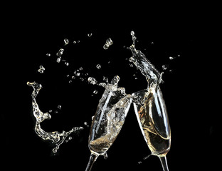 Wall Mural - Glasses of champagne with splash, on black background