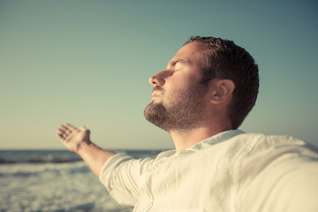 Happy man enjoying life at the beach