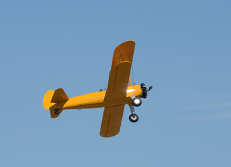 Canvas Print - Old yellow biplane in flight