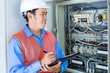 © Kzenon - Asian Electrician at panel on construction site
