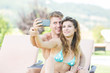 © william87 - Young Couple on Vacation Taking Selfie