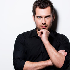 Wall Mural - Fashion portrait of young man in black shirt .