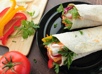 Wraps with fresh chicken and vegetables on a plate