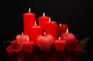 Poster - Beautiful candles with flowers isolated on black