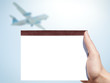 white blank notebook in woman hand and airplane background