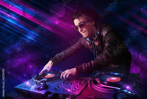 Board z aluminiowym obramowaniem Młody dj grający na gramofonach z kolorowymi efektami świetlnymi