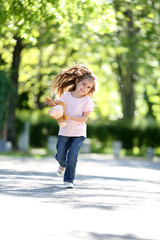 Wall Mural - Happy little girl in the green park