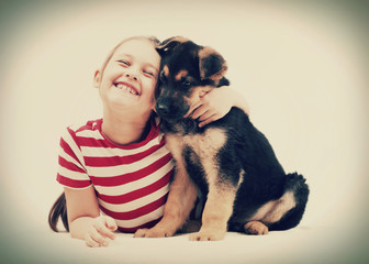 Wall Mural - child hugging a puppy