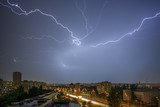 Fototapeta Tęcza - lightning and cityscape