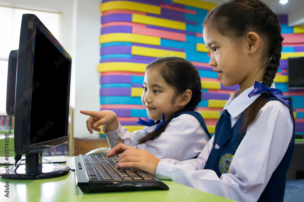 Little cute Asian girl using computer Stock Photo | Adobe Stock