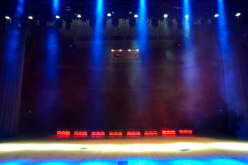 Illuminated empty concert stage with smoke