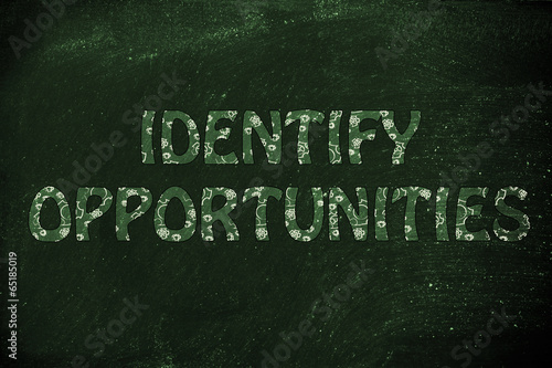 Fotografía Identify Opportunities writing with glowing gearwheels pattern