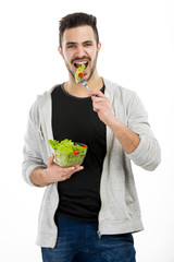 Young man eating a salad