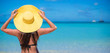© travnikovstudio - Woman sitting in yellow hat on white sand beach enjoying summer