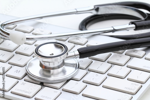 Fotografie, Obraz Stethoscope isolated on white with a modern computer keyboard