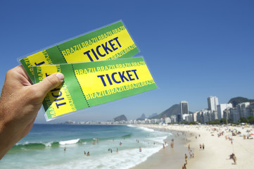 Wall Mural - Hand Holding Brazil Tickets at Copacabana Beach Rio Brazil